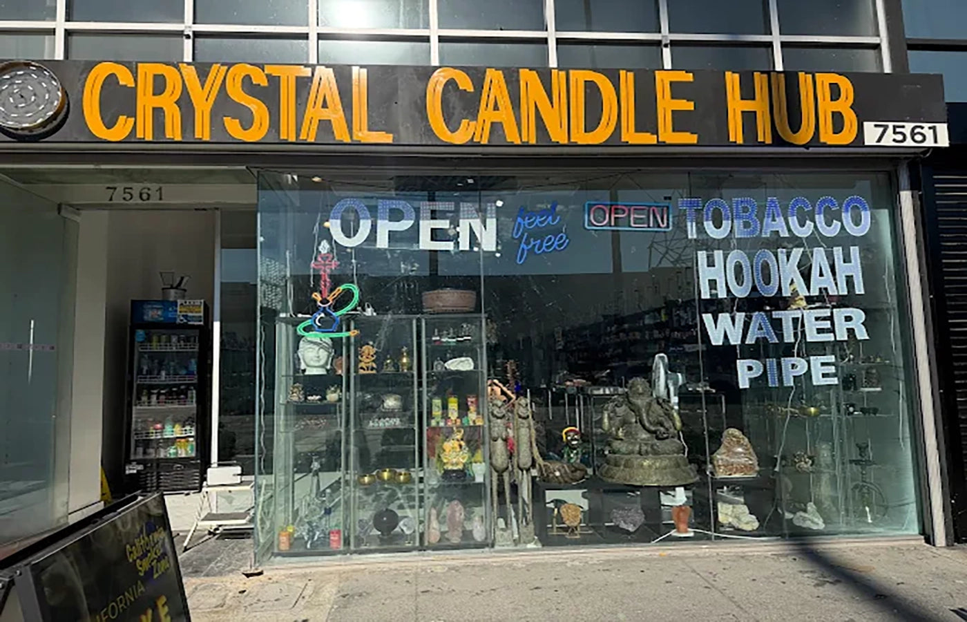  storefront with 'Crystal Candle Hub' sign and display of products