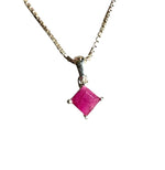 Necklace with a pink gemstone pendant on a white background